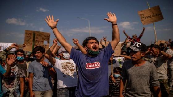 Refugees and migrants from the Moria camp protest near Mytilene on the Greek island of Lesbos, on September 12, 2020, a few days after a fire destroyed the Moria refugee camp. - Tension was simmering on September 12 on Greece's Lesbos island as thousands of asylum seekers remained homeless four days after Europe's largest migrant camp was destroyed by fire. Round-the-clock efforts to find temporary shelter for over 11,000 people including thousands of children were still inadequate, rights groups said as local authorities continued to oppose camp reconstruction plans. (Photo by ANGELOS TZORTZINIS / AFP) (Photo by ANGELOS TZORTZINIS/AFP via Getty Images)